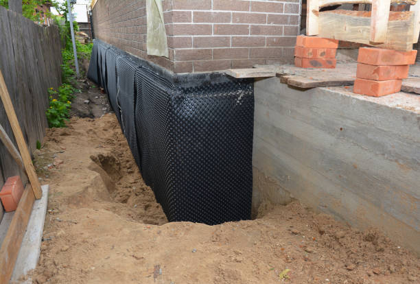 Happy homeowners after waterproofing job in Boswell